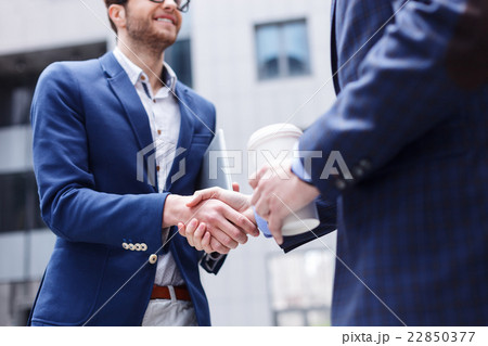 Successful two businessmen doing handshake by 22850377