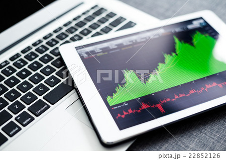 Stock market graphs on tablet pc with laptop computer Stock market graphs on tablet pc with laptop computer 22852126