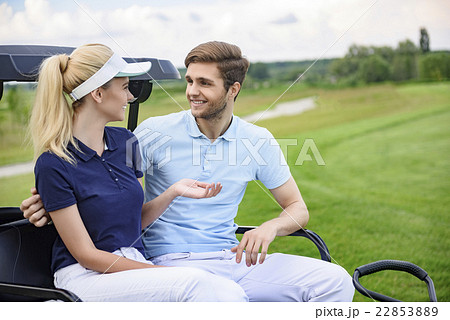 Attractive golfing couple talking 22853889