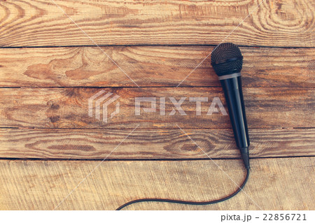 Microphone on wooden background. Toned image. 22856721