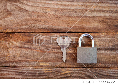 key and lock on wooden background 22856722
