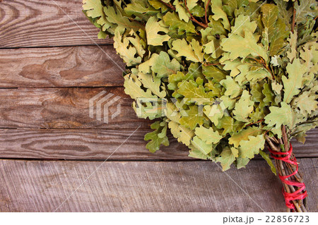 Oak broom for a bath on wooden background.  22856723
