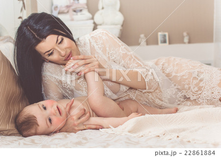 Pretty smiling mother with little baby boy 22861884