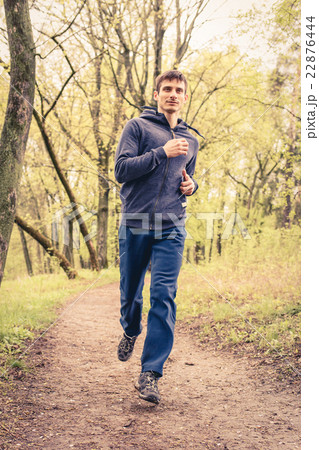 Young trail runner man jogging in the morning park 22876444