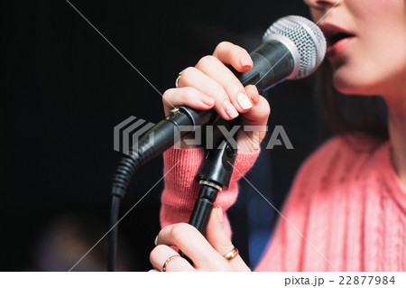 Mic and unrecognizable female singer close up 22877984