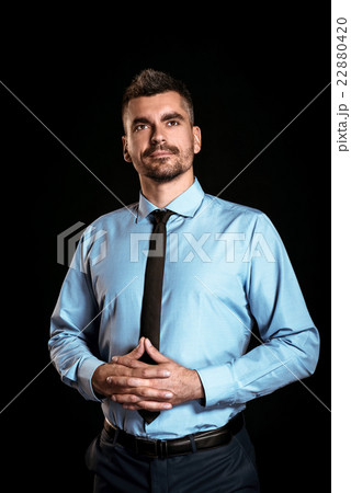 Handsome businessman on black background 22880420