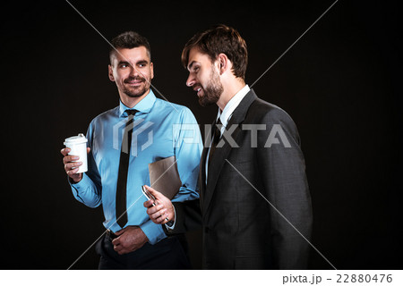 Handsome businessmen on black background Handsome businessmen on black background 22880476