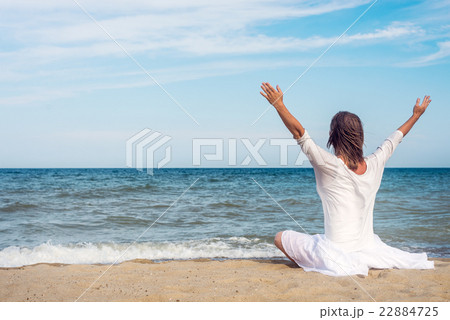 Woman meditating at the sea Woman meditating at the sea 22884725