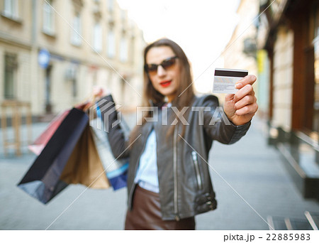 Beautiful woman with shopping bags and credit card 22885983