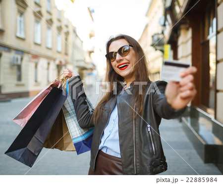 Beautiful woman with shopping bags and credit card 22885984