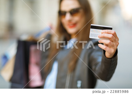 Beautiful woman with shopping bags and credit card 22885986