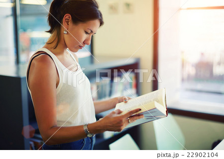 Woman reading book in beautiful light interior Woman reading book in beautiful light interior 22902104