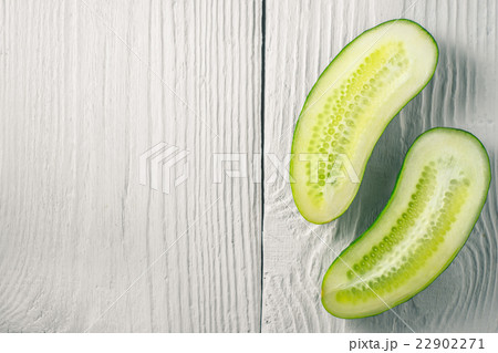 Halved fresh cucumber on the white boards 22902271
