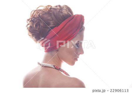 Portrait of a girl with beaded decoration in red turban 22906113