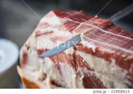 Chef slices serrano ham. 22908615
