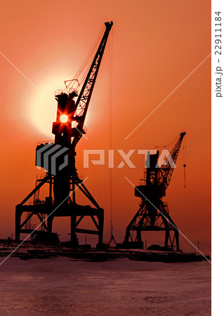 Silhouettes cranes freight ship on shore of Lake Silhouettes cranes freight ship on shore of Lake 22911184