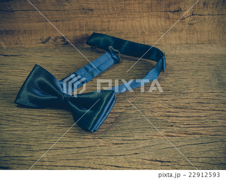 Dark blue bow tie on the wooden table  22912593