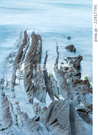 Twilight ocean coast with ribbed stratiform rock. Twilight ocean coast with ribbed stratiform rock. 22917795