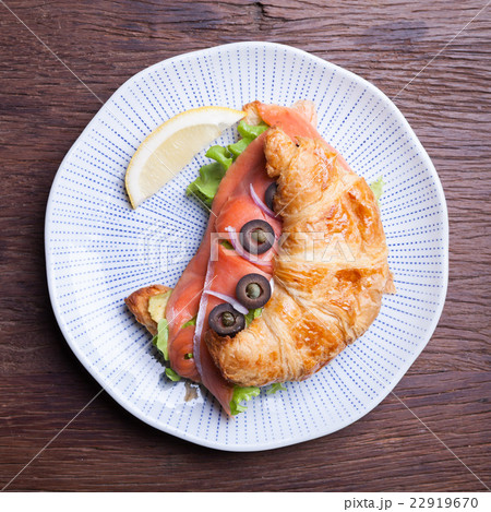 Croissant with salmon and capers Croissant with salmon and capers 22919670