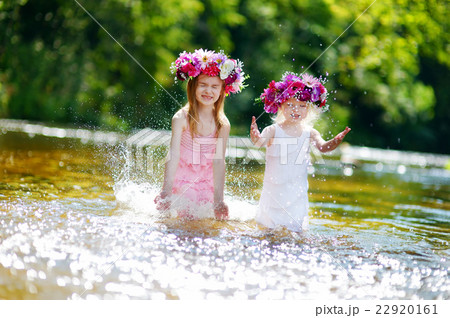 Two sisters having fun by a river Two sisters having fun by a river 22920161