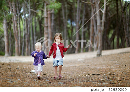 Two sisters having a walk in the woods Two sisters having a walk in the woods 22920290
