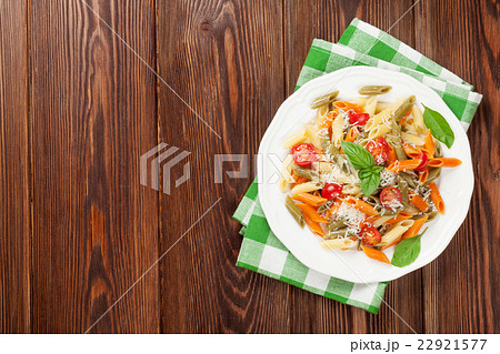 Colorful penne pasta with tomatoes and basil 22921577