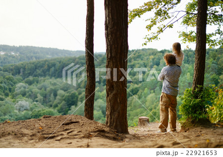 A girl and her father standing on the edge A girl and her father standing on the edge 22921653