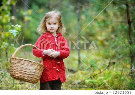 Cute little girl picking mushrooms 22921655