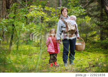 Grandmother and her girls picking mushrooms Grandmother and her girls picking mushrooms 22921656