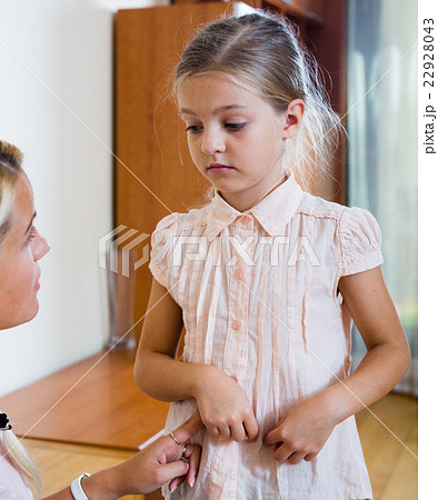 Sick girl with pain in stomach and worried mother indoors 22928043