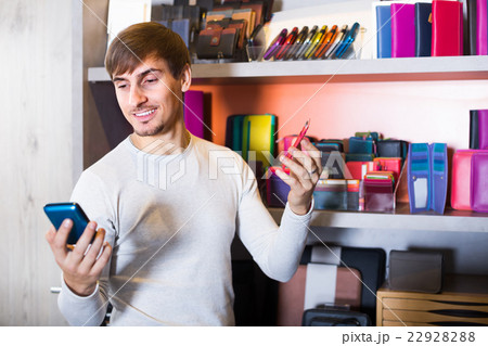 Man choosing wallet in store. Man choosing wallet in store. 22928288