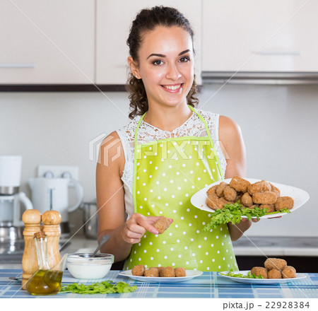 woman posing with plate of deep-fried kroketten 22928384