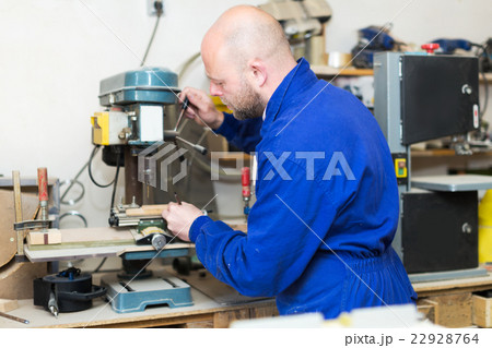 craftsman working with unfinished guitar 22928764