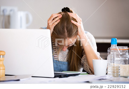 Portrait of upset girl with laptop 22929152