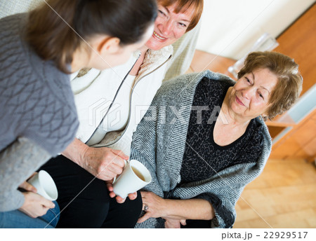 Young girl paying visit to senior grandmothers Young girl paying visit to senior grandmothers 22929517