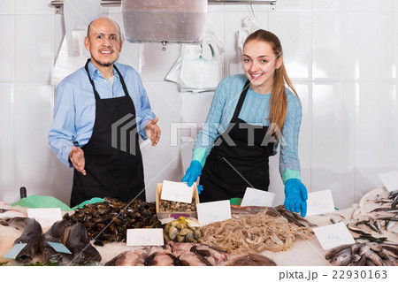 Ordinary fish and seafood store with two sellers Ordinary fish and seafood store with two sellers 22930163