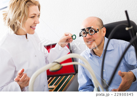 Optician doing eye check up Optician doing eye check up 22930345