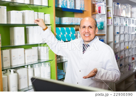 Male pharmacist in drugstore. Male pharmacist in drugstore. 22930390