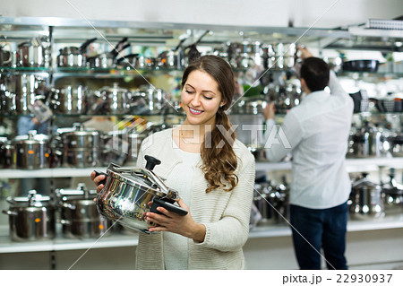Couple buying pans in shop cookware. Couple buying pans in shop cookware. 22930937