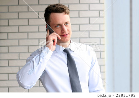 businessman calling on smartphone over office 22931795