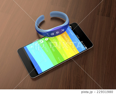 木目の机にあるスマートフォンとスマートバンド 22931980