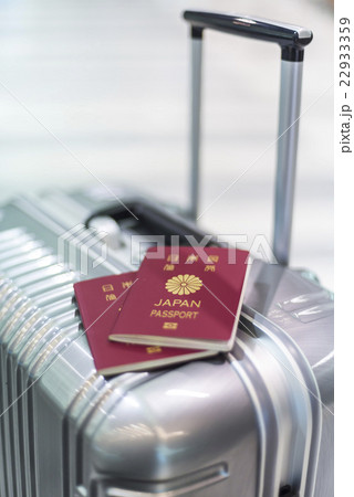 キャリーケースの上の二冊のパスポート 22933359