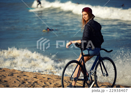 Young woman standing on seashore enjoying rest Young woman standing on seashore enjoying rest 22938407