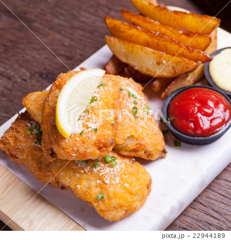 Fish and chips with potato wedge.. 22944189