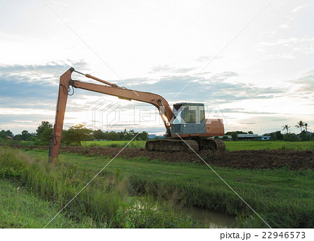 The big backhoe excavator machine in rice field 22946573