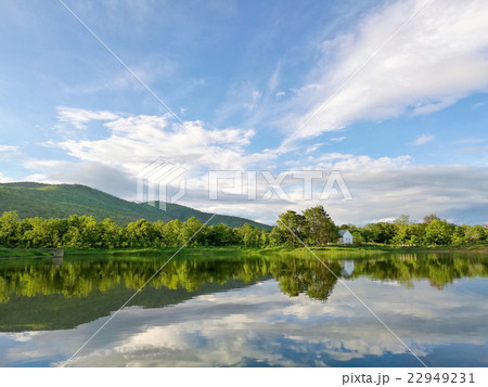 Reflection of natural tree and sky in a lake 22949231