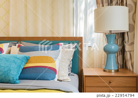 colorful pillows on wooden bed in modern bedroom 22954794