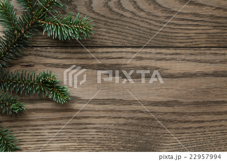 fir branch on stained oak table from above 22957994
