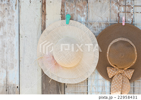 Straw hats for sale, hanging on a wall.. Straw hats for sale, hanging on a wall.. 22958431