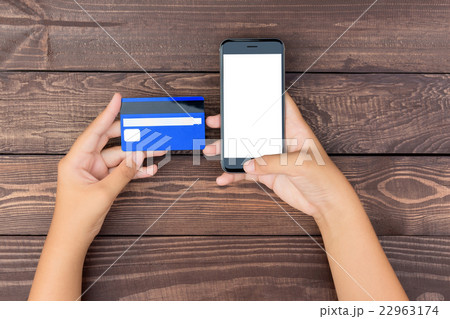 closeup hand use phone and credit card on table 22963174